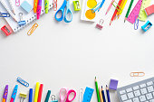 istock Frame of shcool supplies and keyboard on white background. Back to school, distance learning online concept. Flat lay, top view, overhead. 1333039392