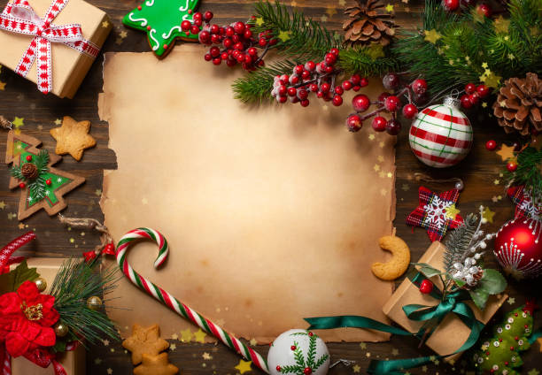 frame with vintage paper, fir branches, cookies and christmas decorations on dark wooden background. - christmas magic imagens e fotografias de stock