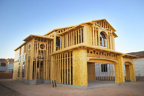 Framed house under construction A house in the framing stages. house   neighborhood  wood stock pictures, royalty-free photos & images