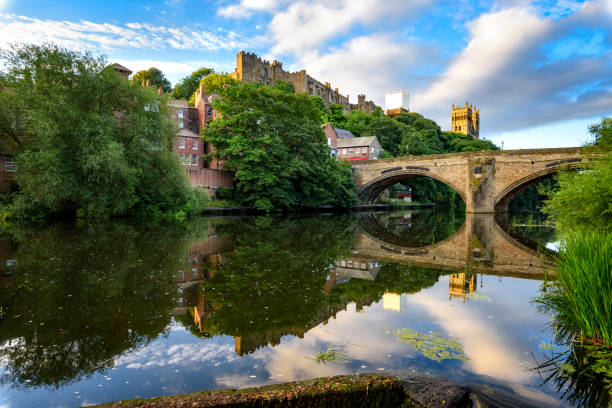 Framwellgate Bridge Durham UK The Wear flows past Durham Castle and Cathedral, beneath Framwellgate Bridge and over a weir. durham stock pictures, royalty-free photos & images