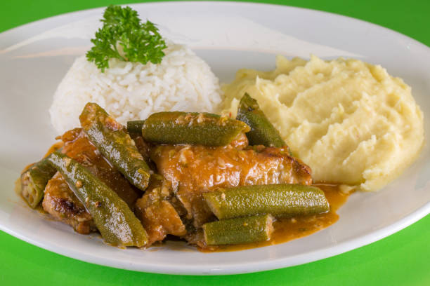 Frango com quiabo. Brazilian food. A chicken meal with okra served with rice and mashed potatoes. Frango com quiabo. Brazilian food. A chicken meal with okra served with rice and mashed potatoes. okra photos stock pictures, royalty-free photos & images