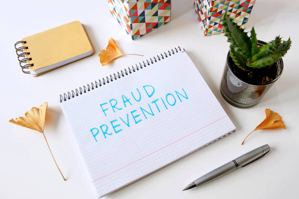 fraud prevention written in a notebook stock photo
