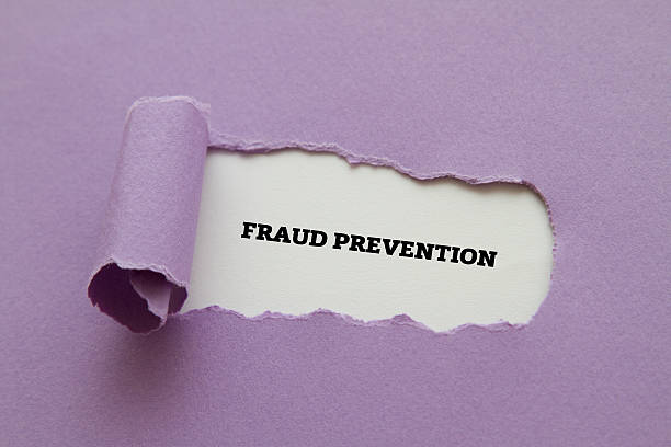 Fraud Prevention written under torn paper. stock photo