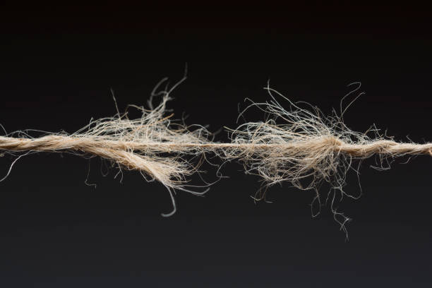 Frayed rope ready to break on dark background  frayed thread stock pictures, royalty-free photos & images