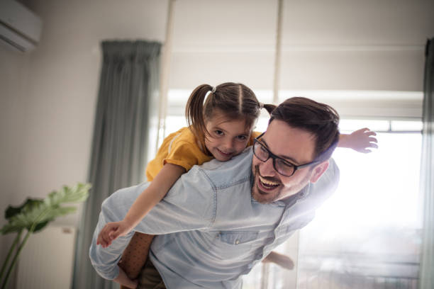 Free as can be. Free as can be. Father and daughter having fun at home. fathers day stock pictures, royalty-free photos & images