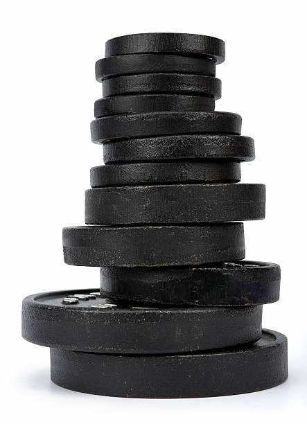 Free weights stacked largest to smallest  Different iron disc weights unit (plates) isolated on white. Clipping path incl. weight stock pictures, royalty-free photos & images