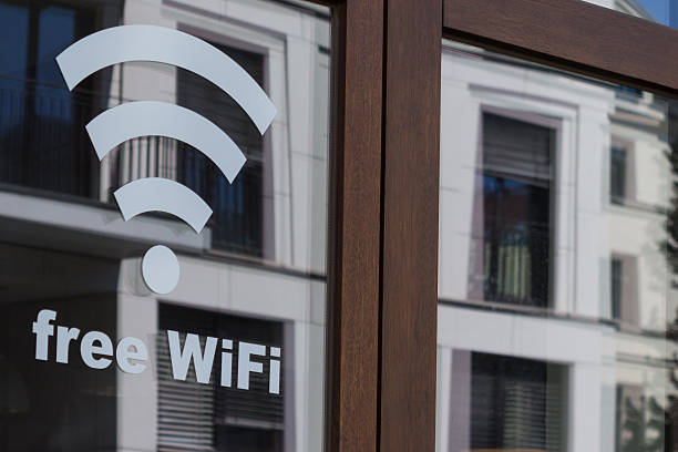 free wifi symbol - wireless internet icon on shop window stock photo