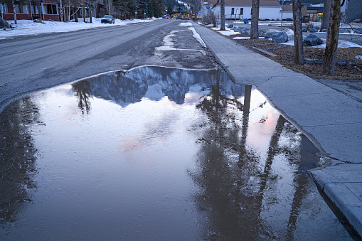 Freezing pool of water on the street in Canmore, Alberta, Canada