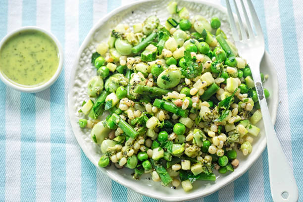 Fregola pasta & greens salad. Courgette, green beans, toasted fregola pasta with lemon & parsley dressing. Fregola pasta & greens salad. Courgette, green beans, toasted fregola pasta with lemon & parsley dressing. broad bean stock pictures, royalty-free photos & images