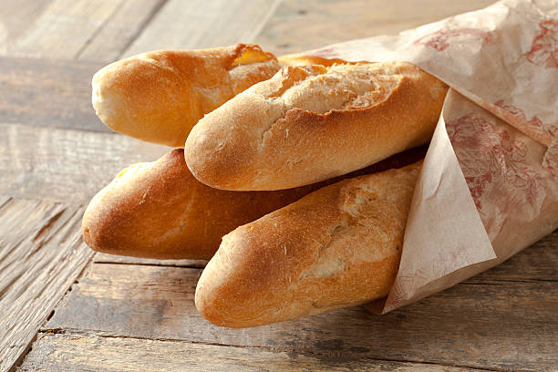 French baguettes French baguettes wrapped in paper baguette photos stock pictures, royalty-free photos & images