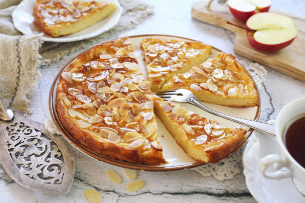 French cuisine. Invisible apple tart, almond petals dressing and tea stock photo