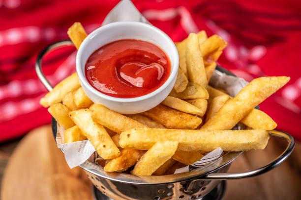 French Fries and Sauce Golden French Fries in a metal colander with Tomato Sauce in a small white bowl ketchup stock pictures, royalty-free photos & images