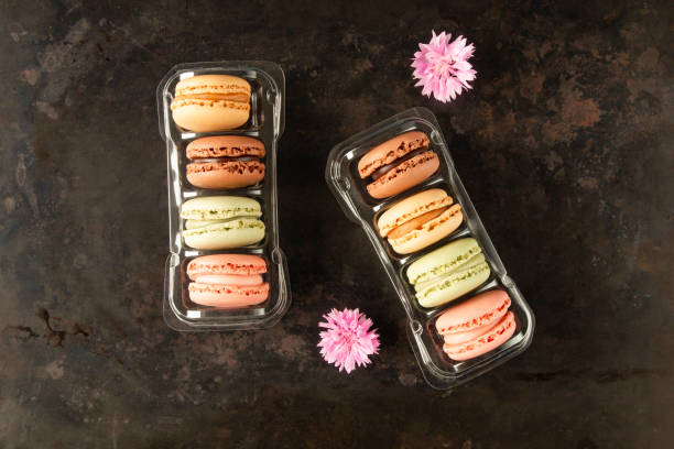 French macaroons in boxes on dark background stock photo