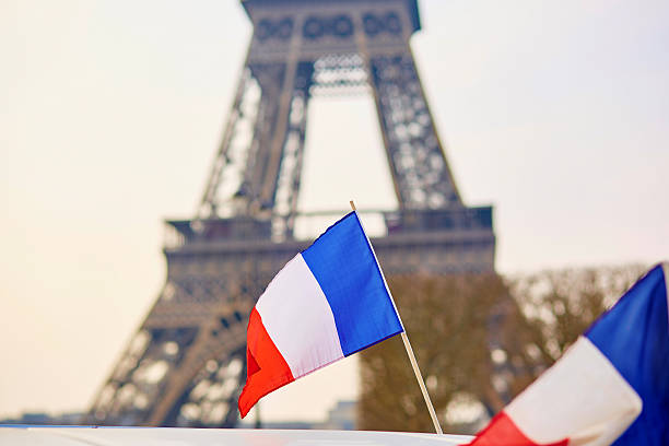 French national flag French national flag (tricolour) in Paris with the Eiffel tower in the background 2015 stock pictures, royalty-free photos & images