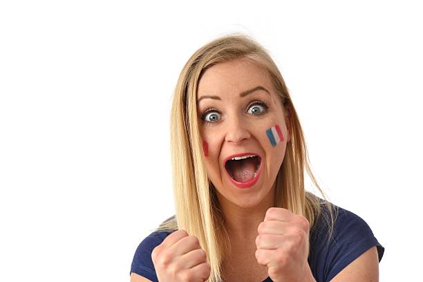 French soccer fan cheers football team in the national colors. stock photo