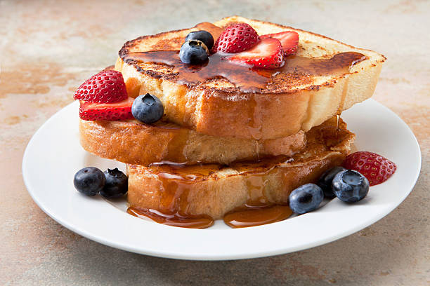 French Toast With Fruit and Syrup on a Marble Countertop. stock photo