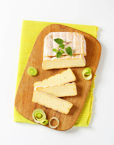 French washed rind cheese French soft cheese with chopped leek on cutting board muenster cheese stock pictures, royalty-free photos & images