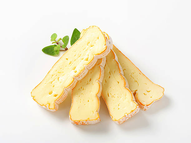 French washed rind cheese Slices of Alsatian Munster cheese muenster cheese stock pictures, royalty-free photos & images