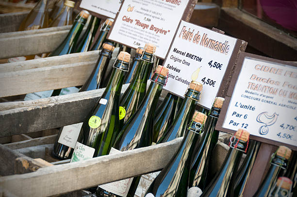 French Wine Market "Hornfleur, France -September 24th, 2011; Locally produce Calvados (pear cider) on sale at the Traditional French market" calvados stock pictures, royalty-free photos & images