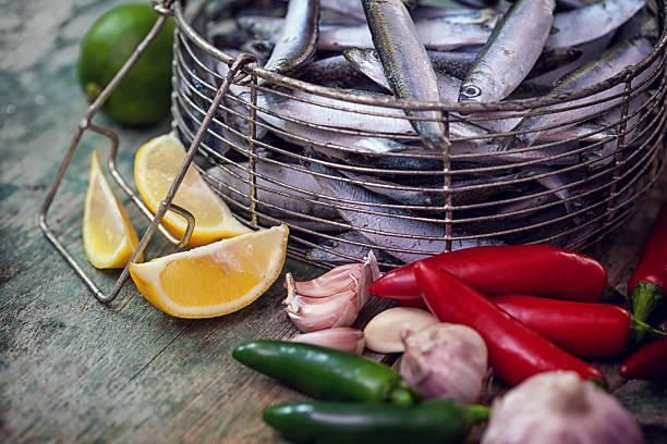 Fresh anchovy with garlic, lemon and jalapeno peppers stock photo