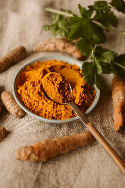 Fresh and organic turmeric root and powder as background. Curcuma longa. Natural and healthy food. Indian spice. Fresh and organic turmeric root and powder as background. Curcuma longa. Natural and healthy food. Indian spice. turmeric stock pictures, royalty-free photos & images