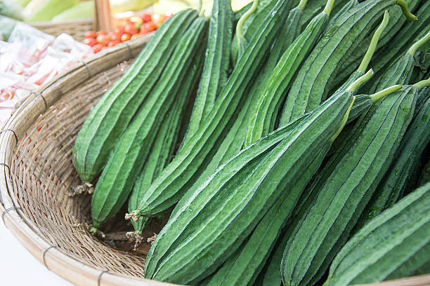 Fresh Angled loofah, Angled Gourd (Luffa acutangula Roxb.) fruit Fresh Angled loofah, Angled Gourd (Luffa acutangula Roxb.) fruits in basket mountain ridge stock pictures, royalty-free photos & images
