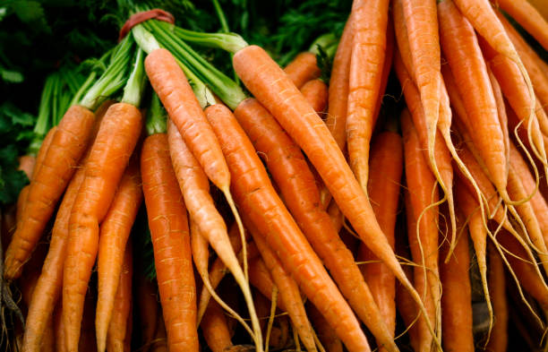 Fresh baby carrots at the local market stock photo