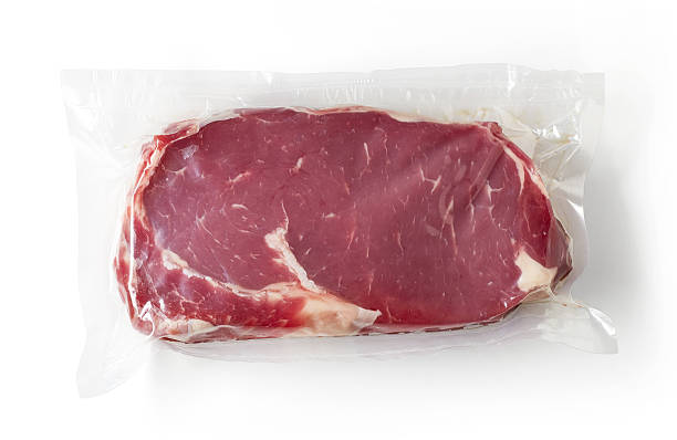 Fresh beef steak for sous vide cooking, isolated on white Vacuum sealed fresh beef steak for sous vide cooking isolated on white background, top view airtight stock pictures, royalty-free photos & images