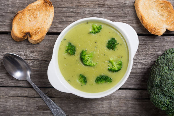 Fresh broccoli cream soup in bowl stock photo