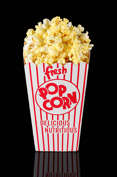 Fresh buttered popcorn in retro red striped theatre box stock photo