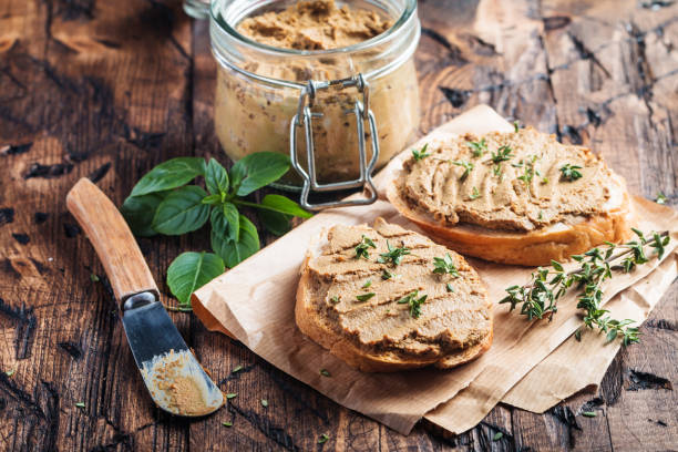 Fresh chicken liver pate Fresh homemade chicken liver pate on bread over rustic background casserole dish stock pictures, royalty-free photos & images