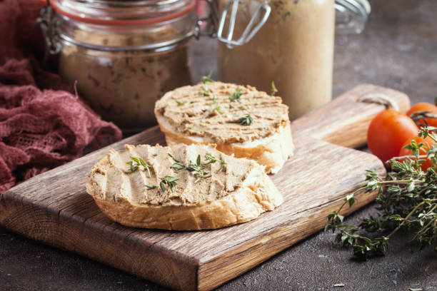 Fresh chicken liver pate Fresh homemade chicken liver pate on bread over rustic background pate photos stock pictures, royalty-free photos & images