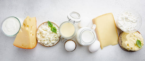 Fresh dairy products Fresh dairy products, milk, cottage cheese, eggs, yogurt, sour cream and butter on white background, top view dairy product stock pictures, royalty-free photos & images