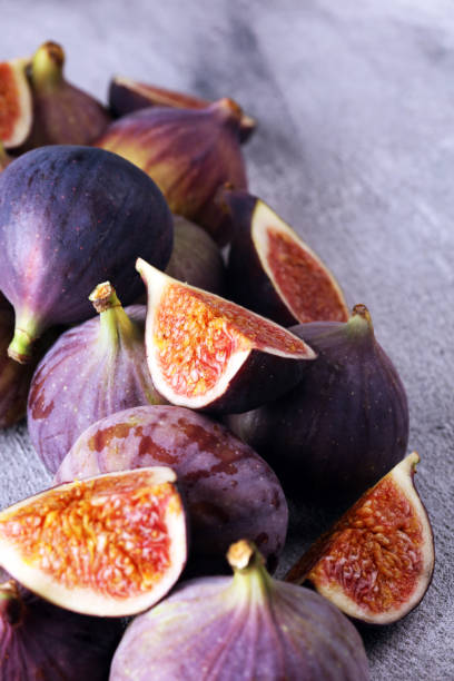 Fresh figs. Food Photo. whole and sliced figs on beautiful rustic background. stock photo