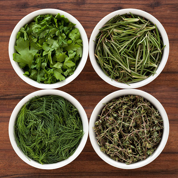 Fresh herbs Four bowls containing varieties of fresh herbs (parsley, rosemary, dill and thyme) dill stock pictures, royalty-free photos & images