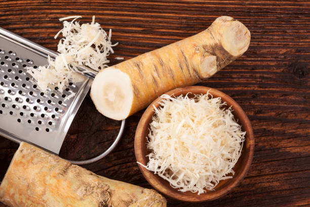 Fresh Horseradish root Fresh grated Horseradish roots on wooden table. Rustic style from above. horseradish stock pictures, royalty-free photos & images