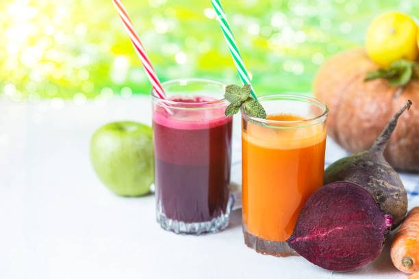 fresh juice from homemade vegetables. Beet and carrot smoothie. Detox, vegetarianism On a bright summer background stock photo