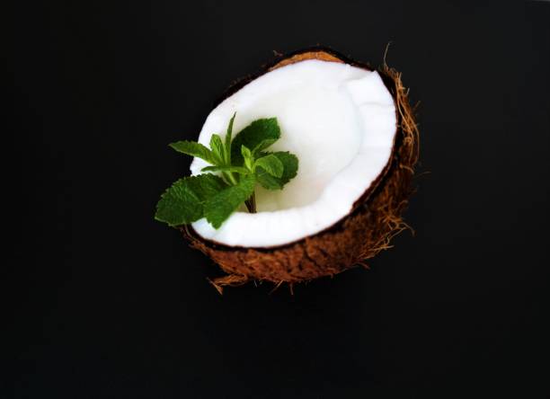 fresh juicy coconut with green mint leaves stock photo