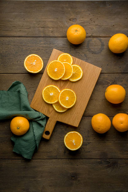 Fresh juicy vitamin oranges on wooden board. Food background. Vertical, top view stock photo