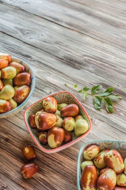 Fresh Jujube or Chinese Red Date Served on Rustic Wooden Backgrounds stock photo