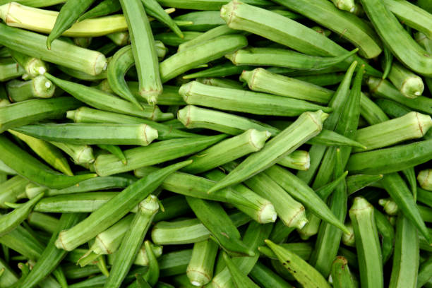 Fresh ladyfinger at vegetable market Fresh ladyfinger at vegetable market in Tamilnadu, India. okra photos stock pictures, royalty-free photos & images