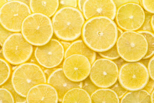 Fresh lemon slices pattern background, close up stock photo