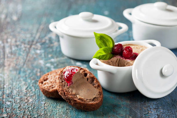 Fresh liver pate Fresh homemade chicken liver pate with cranberry sauce in ceramic serving pans and slices keto bread, selective focus pate stock pictures, royalty-free photos & images