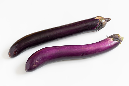 Fresh long eggplant closeup isolated on white background