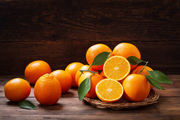 fresh orange fruits with leaves stock photo