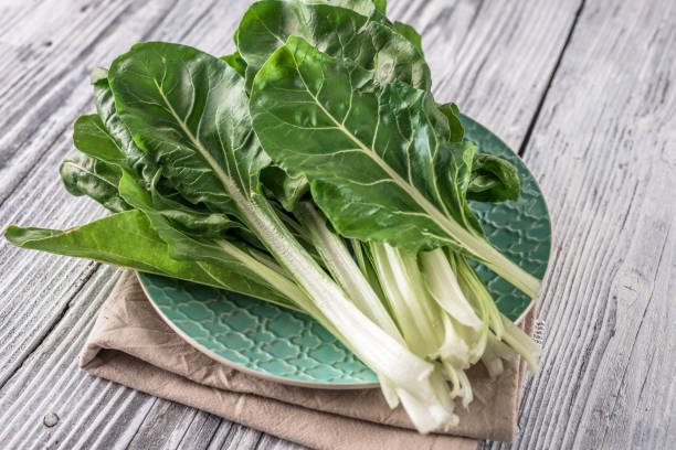 Fresh organic chard on a rustic background Fresh organic chard on a rustic background chard stock pictures, royalty-free photos & images
