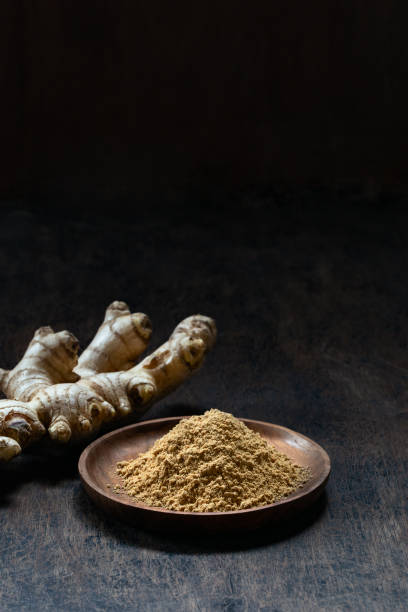 Fresh organic ginger root on dark old rustic background with copyspace. stock photo