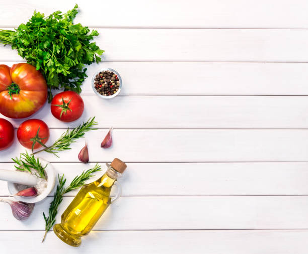 Fresh organic ingridients of italian recipes. Healthy food concept on white wooden table background. Top view, copy space stock photo