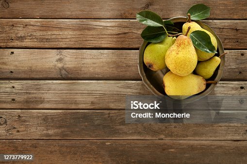 istock Fresh Organic Pears On An Old Wooden Background 1273779922
