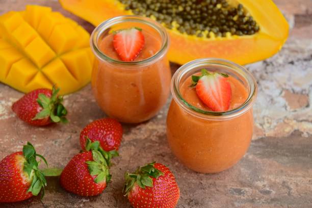 Fresh organic strawberry mango papaya smoothie Fresh organic strawberry mango papaya smoothie papaya smoothie stock pictures, royalty-free photos & images